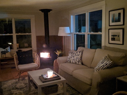 living room at Harbour Tide House nova scotia with a working fireplace.